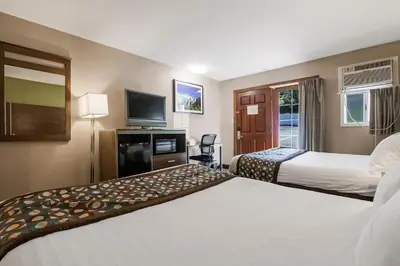 a hotel room with two beds and a television at Heritage Inn - Yosemite/Sonora in Sonora