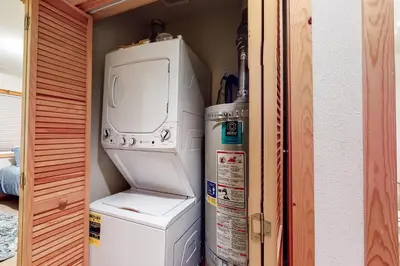 a washer and dryer in a room with a refrigerator at Trout Creek Condo in Truckee