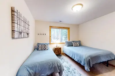 a bedroom with two beds and a window at Trout Creek Condo in Truckee