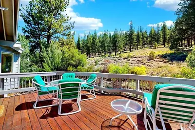 a deck with chairs and a table with a view at Sleek Hill Haven with Martis Valley Views in Polaris