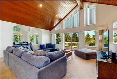 a large living room with couches and a television at Sleek Hill Haven with Martis Valley Views in Polaris