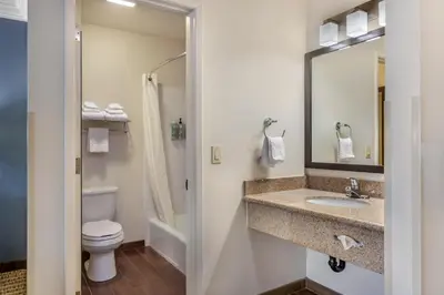 a bathroom with a sink and a toilet at Best Western Town & Country Lodge in Tulare