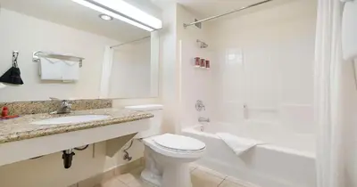 a bathroom with a toilet and a sink and a shower at SureStay Plus Hotel by Best Western Rocklin in Rocklin