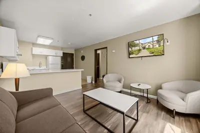 a living room with a couch and chairs and a table at SureStay Plus Hotel by Best Western Rocklin in Rocklin