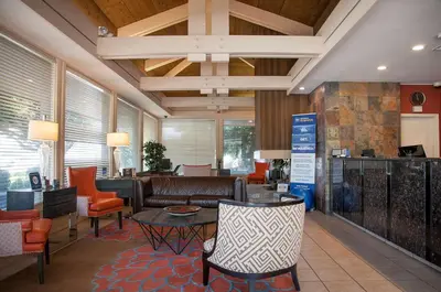 a lobby with a couch and chairs and a table at Best Western Village Inn in Fresno