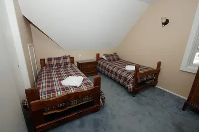 two beds in a room with a attic at 3664 Birch Avenue cabin in South Lake Tahoe