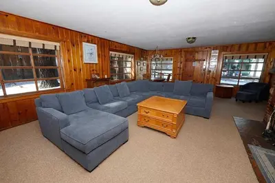 a living room with a blue couch and a table at 3664 Birch Avenue cabin in South Lake Tahoe
