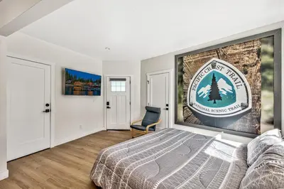 a bedroom with a bed and a sign on the wall at The Historic West Walker Motel in Walker