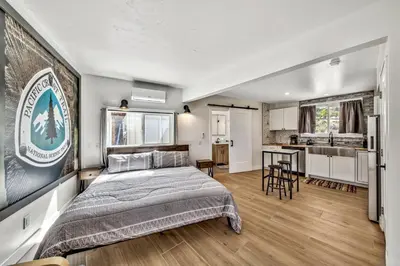 a bedroom with a large bed and a kitchen at The Historic West Walker Motel in Walker