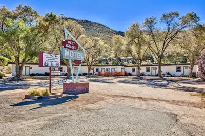 a motel with a sign in the middle of a dirt road at The Historic West Walker Motel in Walker