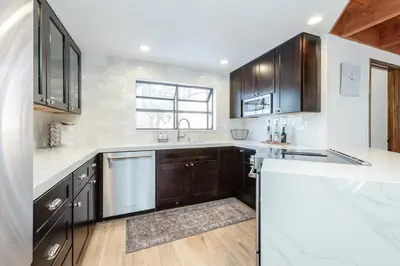a kitchen with wooden cabinets and white counter tops at Snowflower 12 in Mammoth Lakes