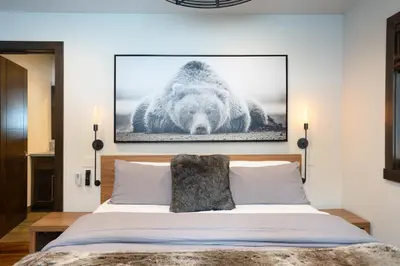 a bedroom with a bed with a picture of a bear at West Shore - West Shore Hideaway in Tahoma