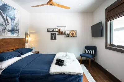 a bedroom with a bed and a ceiling fan at West Shore - West Shore Hideaway in Tahoma