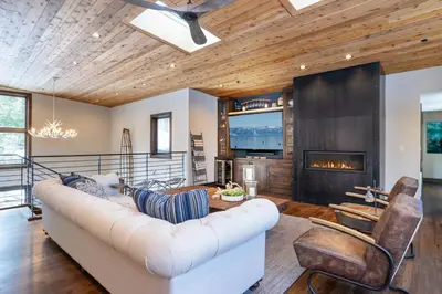 a living room with a white couch and a fireplace at West Shore - West Shore Hideaway in Tahoma