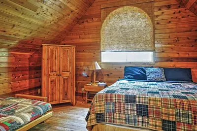 a bedroom with a bed in a wooden cabin at Hot Tub, Deck and Trail Access Shaver Lake Cabin in Shaver Lake
