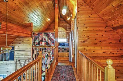 a staircase in a cabin with wooden walls at Hot Tub, Deck and Trail Access Shaver Lake Cabin in Shaver Lake