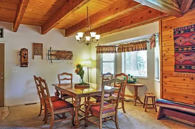 a dining room with a wooden table and chairs at Hot Tub, Deck and Trail Access Shaver Lake Cabin in Shaver Lake