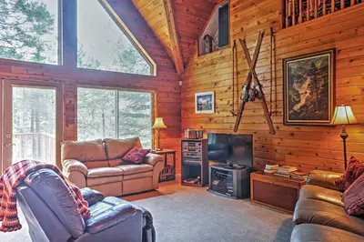 a living room with furniture and a tv in a cabin at Hot Tub, Deck and Trail Access Shaver Lake Cabin in Shaver Lake