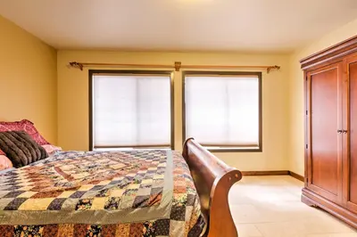a bedroom with a bed and two windows at Cozy Lake-View Hideaway! Pet-Friendly Truckee Home in Truckee