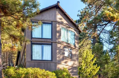 a wooden house with windows and trees at Cozy Lake-View Hideaway! Pet-Friendly Truckee Home in Truckee