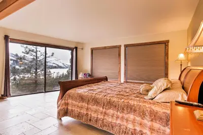 a bedroom with a bed and large windows at Cozy Lake-View Hideaway! Pet-Friendly Truckee Home in Truckee