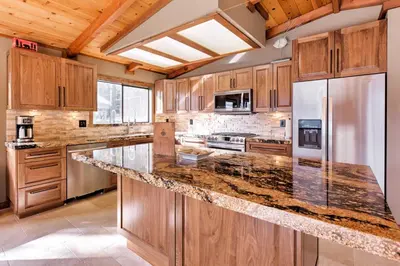 a large kitchen with wooden cabinets and granite counter tops at Cozy Lake-View Hideaway! Pet-Friendly Truckee Home in Truckee