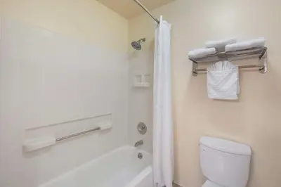a bathroom with a tub and a toilet and a shower at Best Western Plus Orchid Hotel & Suites in Roseville