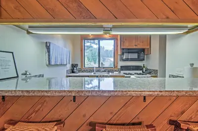 a kitchen with a counter top and wooden floors at Northstar Resort Shuttle Access Truckee Condo in Truckee