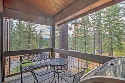 a screened in porch with a table and chairs at Northstar Resort Shuttle Access Truckee Condo in Truckee