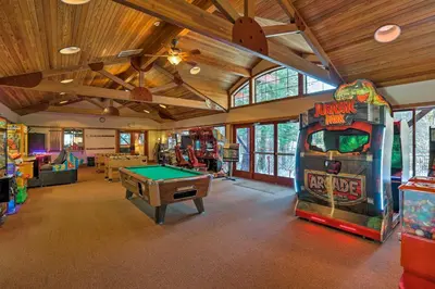 a room with a pool table and a arcade game at Northstar Resort Shuttle Access Truckee Condo in Truckee