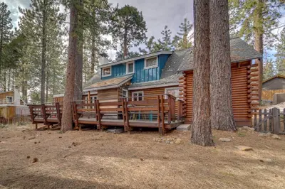 a log cabin in the woods with two trees at Boutique and Artsy Log Cabin in North Lake Tahoe! in Kings Beach