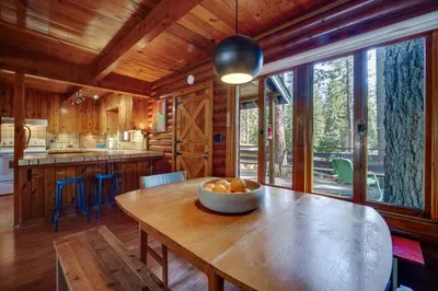 a kitchen with a table with a bowl of fruit on it at Boutique and Artsy Log Cabin in North Lake Tahoe! in Kings Beach