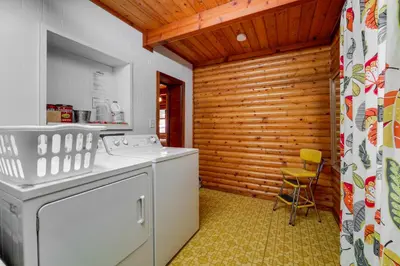 a kitchen with a washer and dryer in a room at Boutique and Artsy Log Cabin in North Lake Tahoe! in Kings Beach