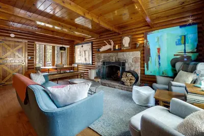 a living room with couches and a fireplace at Boutique and Artsy Log Cabin in North Lake Tahoe! in Kings Beach