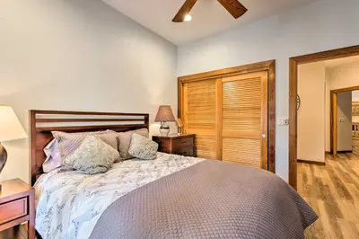 a bedroom with a bed with a wooden headboard at Forest-View Gem 2 Mi to Diamond Peak Ski Resort! in Incline Village