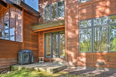 a wooden house with a chair in front of it at Forest-View Gem 2 Mi to Diamond Peak Ski Resort! in Incline Village