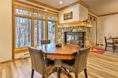 a dining room with a table and a fireplace at Forest-View Gem 2 Mi to Diamond Peak Ski Resort! in Incline Village