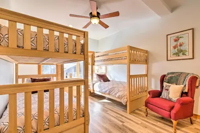 a bedroom with two bunk beds and a red chair at Forest-View Gem 2 Mi to Diamond Peak Ski Resort! in Incline Village