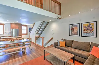 a living room with a couch and a table at Modern Condo with Balcony - Walk to Northstar Lifts! in Truckee