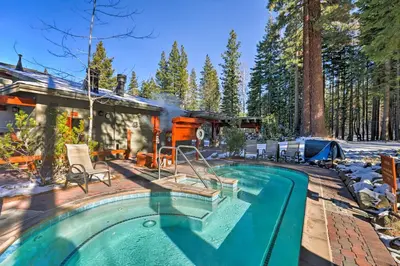 a house with a swimming pool next to a house at Modern Condo with Balcony - Walk to Northstar Lifts! in Truckee
