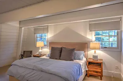 a bedroom with a large bed and two lamps at 10 Mi to Skiing Tahoe City A-Frame Home in Tahoe City
