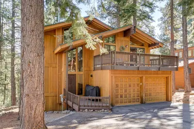 a house in the woods with a balcony at Family-Friendly Truckee Cabin Near Ski Shuttle! in Truckee