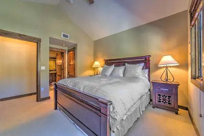 a bedroom with a large bed with a wooden headboard at Central Mammoth Lakes Townhome about 1 Mi to Slopes in Mammoth Lakes