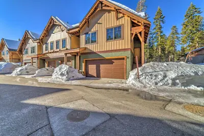 a wooden house with a garage in the snow at Central Mammoth Lakes Townhome about 1 Mi to Slopes in Mammoth Lakes