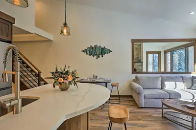 a kitchen and living room with a couch and a table at Walk to Ski Shuttle Truckee Condo with Hot Tub in Truckee