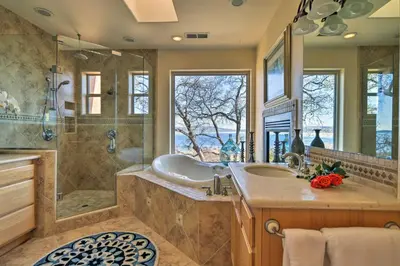 a bathroom with a tub and a sink and a shower at Casa dAmore Extravagant Lakefront Villa! in Granite Bay
