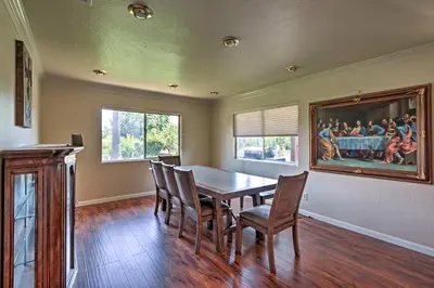 a dining room with a wooden table and chairs at 7 Mi to Dtwn Gilroy Spacious Home on 20 Acres! in Gilroy
