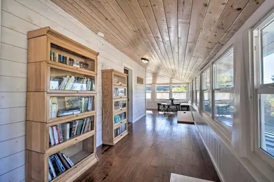a home library with bookshelves and a wooden ceiling at Historic Mariposa Stagecoach Stop with Gas Fire Pit! in Mariposa