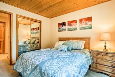 a bedroom with a bed and a dresser and a mirror at Hot Tub Access, Near Skiing Tahoe Donner Cabin in Truckee