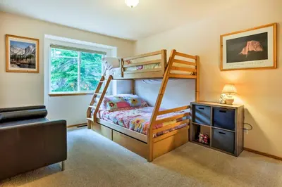 a bedroom with two bunk beds and a window at Hot Tub Access, Near Skiing Tahoe Donner Cabin in Truckee